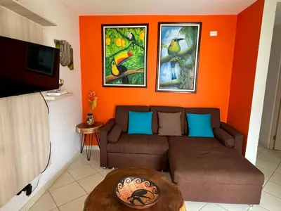 a living room with a couch and paintings on the wall at The Nest 2 bedroom1 bath Condo Rooftop patio in Coco