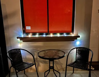 two chairs and a table in a room with lights at Two Palms Ground Floor Unit Across from Beach in Coco
