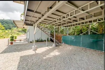 an empty building with a staircase and a fence at CANTO DEL RIO-Rivas- vista a la montaña- tranquilo in Rivas