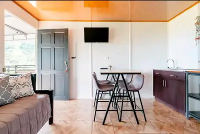 a living room with a couch and a table at CANTO DEL RIO-Rivas- vista a la montaña- tranquilo in Rivas