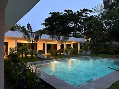 a swimming pool in front of a house at Hotel Good Life in Coco