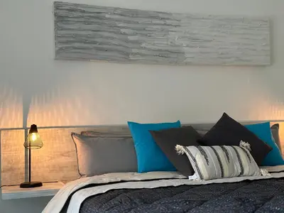 a bedroom with a bed with blue and grey pillows at Hotel Good Life in Coco