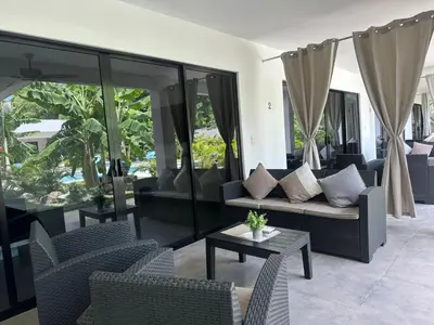 a living room with a couch and chairs and a table at Hotel Good Life in Coco