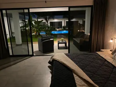 a bedroom with a bed and a view of a patio at Hotel Good Life in Coco