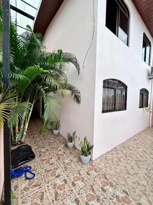 a courtyard with potted plants next to a building at Apartamento Caribe Rosa in Puerto Limón