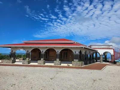a building with a red roof on top of it at Casona Cocobolo el mejor lugar de Costa Rica in Guanacaste