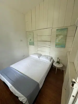 a bedroom with a large bed and a table at Hostel Los Pargos in Río Sequito
