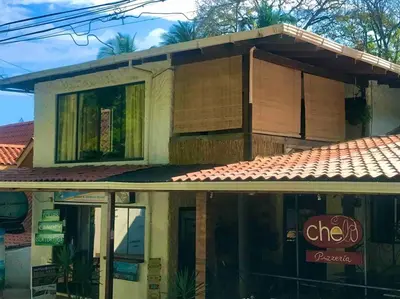 a building with a sign in front of it at Lofty, fully equipped apartment in the heart of Montezuma in Puntarenas