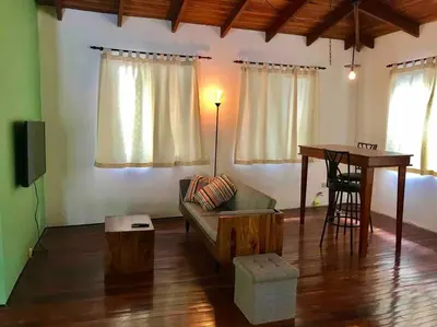 a living room with a couch and a table at Lofty, fully equipped apartment in the heart of Montezuma in Puntarenas
