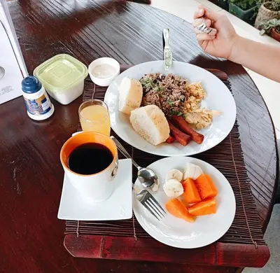 a table with two plates of food and a cup of coffee at Hotel Tierra De Volcanes in Fortuna