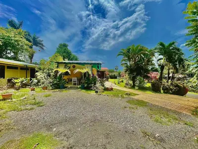 a house with a gravel driveway in front of it at Hotel Tierra De Volcanes in Fortuna