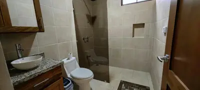 a bathroom with a toilet and a sink and a shower at Casita el Corral in Nuevo Arenal