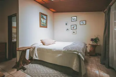 a bedroom with a bed in the corner of a room at Santuario Ecologico Monteverde in Monteverde Costa Rica