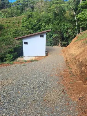 a white building on the side of a road at La cabaña del Dulce in San Rafael Norte