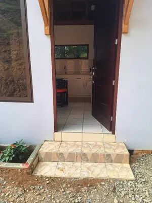 an open door of a house with a patio at La cabaña del Dulce in San Rafael Norte