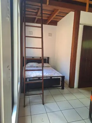 a bedroom with a bunk bed with a ladder at La cabaña del Dulce in San Rafael Norte