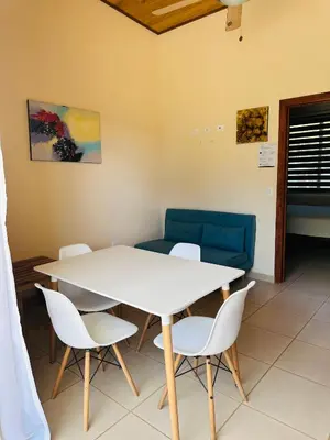 a room with a table and chairs and a couch at La Laguna in Nosara