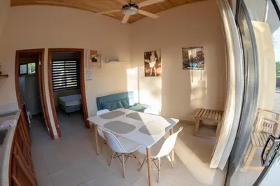 a dining room with a table and chairs in a room at La Laguna in Nosara