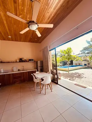a kitchen with a ceiling fan and a table and chairs at La Laguna in Nosara
