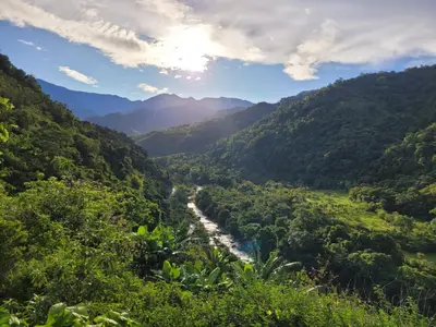 a valley in the mountains with a river at Chirripó Oasis in Canaán