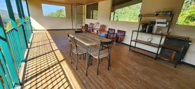 a dining room with a table and chairs at Chirripó Oasis in Canaán