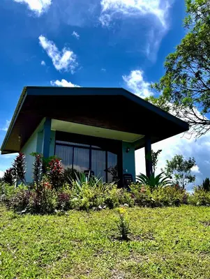 a small house on top of a grass field at Paraíso privado Arenal Dragonfly in Fortuna