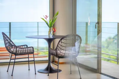 a table and two chairs in a room with a window at Villa Vista Del Mar - by Pura Villas in Dominical