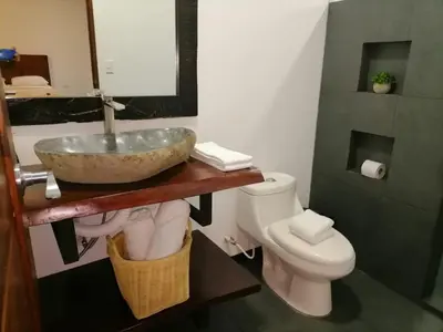 a bathroom with a sink and a toilet at Scala Inn in Muelle