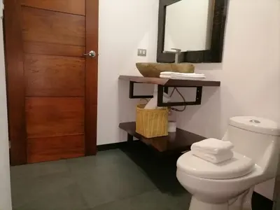 a bathroom with a toilet and a mirror at Scala Inn in Muelle