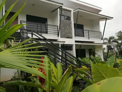 a house with a staircase in front of it at Scala Inn in Muelle