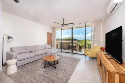 a living room with a couch and a flat screen tv at Villa Maravilla Estates, Tamarindo Beach, Prime Location, Family & Friends in Tamarindo