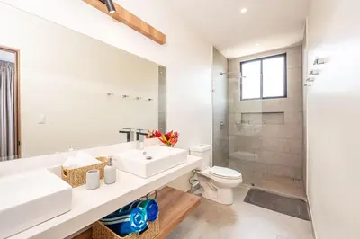 a white bathroom with a sink and a toilet at Villa Maravilla Estates, Tamarindo Beach, Prime Location, Family & Friends in Tamarindo
