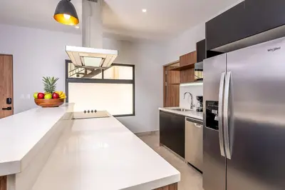 a kitchen with a stainless steel refrigerator and a sink at Villa Maravilla Estates, Tamarindo Beach, Prime Location, Family & Friends in Tamarindo