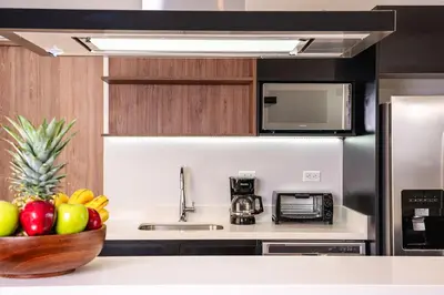 a kitchen with a bowl of fruit on a counter at Villa Maravilla Estates, Tamarindo Beach, Prime Location, Family & Friends in Tamarindo