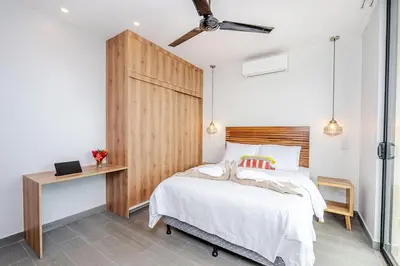 a bedroom with a bed with a wooden headboard at Villa Maravilla Estates, Tamarindo Beach, Prime Location, Family & Friends in Tamarindo