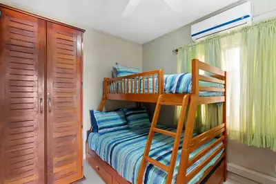 a bedroom with two bunk beds and a closet at Ground-Floor Condo Near Beach & Marina by SPCR in Playa Flamingo