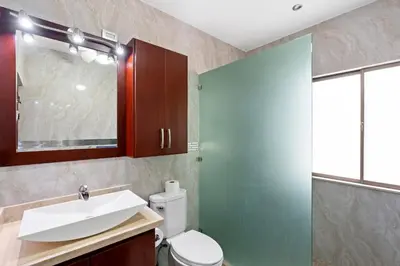 a bathroom with a toilet and a sink and a shower at Ground-Floor Condo Near Beach & Marina by SPCR in Playa Flamingo