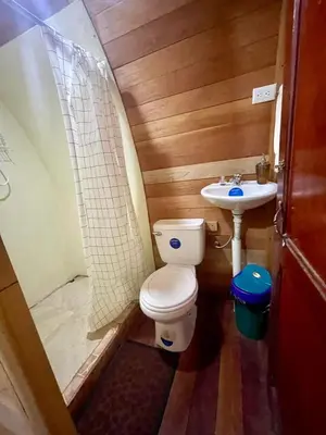 a small bathroom with a toilet and a sink at Gamboa Farm Lodge in Río Cuarto