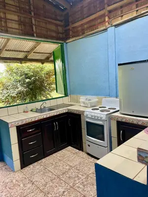 a kitchen with a stove and a sink at Gamboa Farm Lodge in Río Cuarto