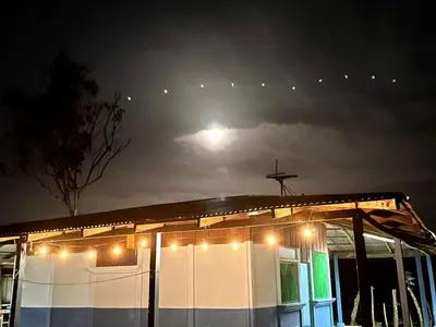 a house with a cross on the roof at night at Gamboa Farm Lodge in Río Cuarto