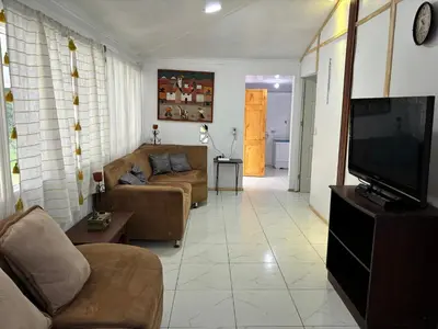 a living room with a couch and a flat screen tv at La casa de la piedra in Monteverde Costa Rica