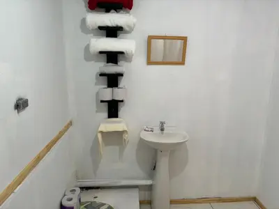a bathroom with a sink and a pile of towels at La casa de la piedra in Monteverde Costa Rica