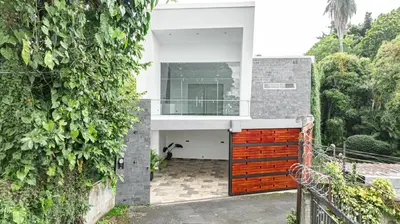 a house with a gate and a ivy wall at Home 333 Habitacion 331 in Escazu