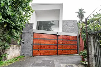 a large wooden garage door on a house at Home 333 Habitacion 331 in Escazu