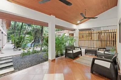 an open porch with chairs and a ceiling fan at Villas Vibras in Playa Avellana