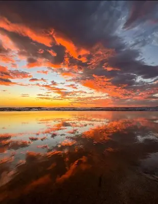 a sunset over the water with a cloudy sky at Villas Vibras in Playa Avellana