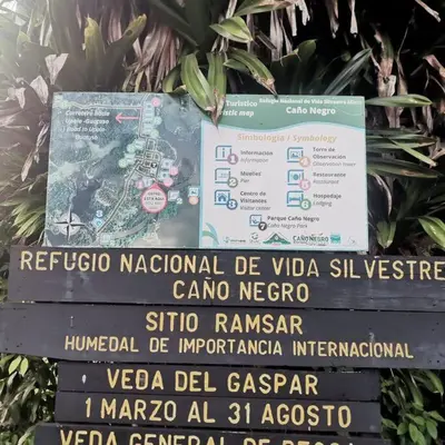 a sign on top of a sign with a map at CañoNegro CasaBlanca in Caño Negro