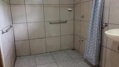 a bathroom with a shower with a tie in it at CañoNegro CasaBlanca in Caño Negro