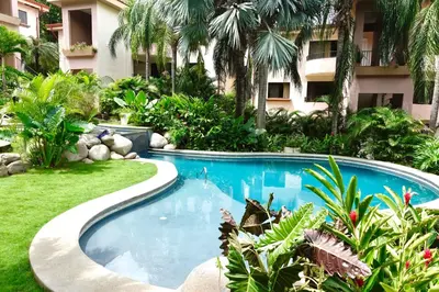 a swimming pool in front of a building at Supreme Serenity 2BR2BA Ocotal Coastal Retreat in Coco