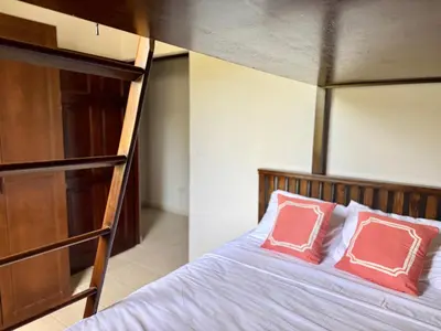 a bedroom with a bunk bed with two pink pillows at Coastal Comfort Spacious Second-Floor Getaway in Coco